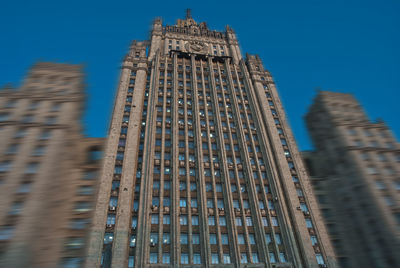 Low angle view of buildings against blue sky