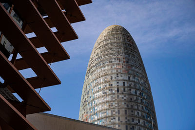 Low angle view of modern building against sky glories building barcelona spain 