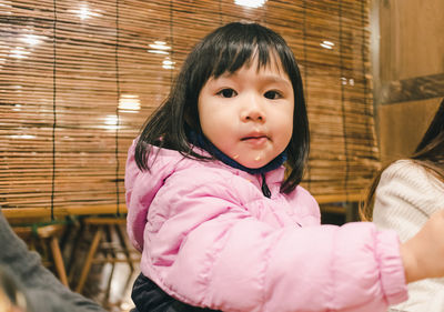 Portrait of cute girl sitting at restaurant