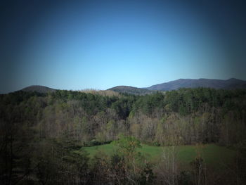 Scenic view of mountains against clear blue sky