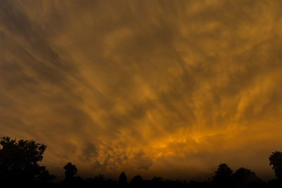 Low angle view of dramatic sky during sunset