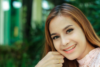 Close-up portrait of smiling young woman