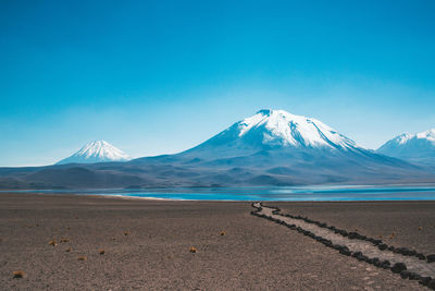 Scenic view of mountains against clear blue sky