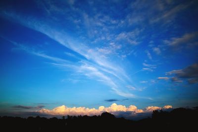 Scenic view of silhouette landscape against blue sky