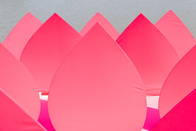 High angle view of pink umbrella on paper