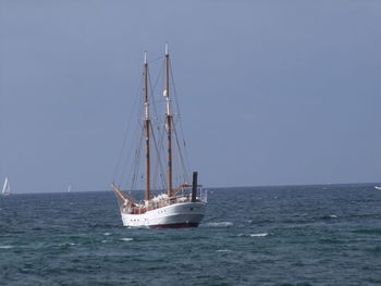Ship sailing on sea against clear sky