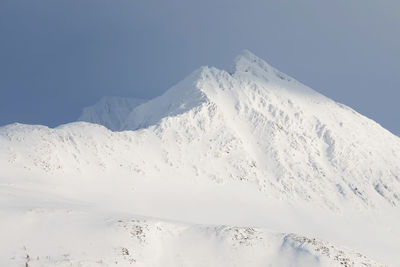 Scenic view of snow covered mountain against sky