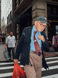 Full length of friends on street in city