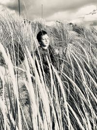 Portrait of woman standing on field during winter