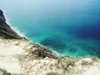 High angle view of sea shore against blue sky