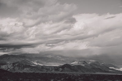 Scenic view of mountains against cloudy sky