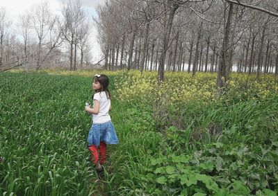 Full length of girl standing on field