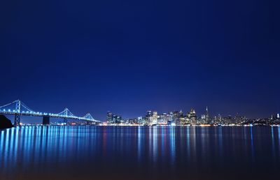 Illuminated city at waterfront