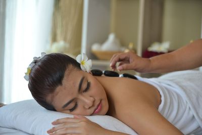 Midsection of woman lying on bed