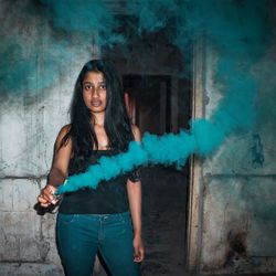 Portrait of woman standing in abandoned building