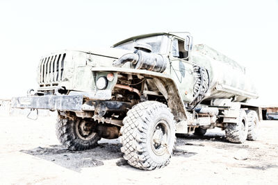 Abandoned truck on road against sky