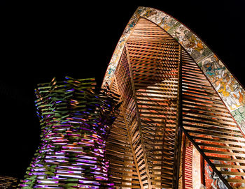 Low angle view of illuminated modern building at night