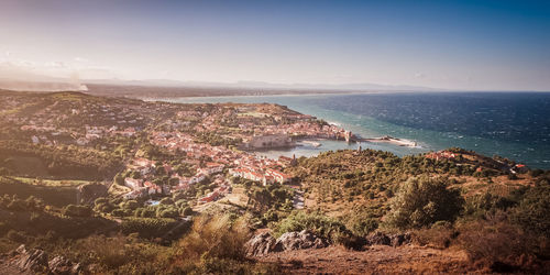 High angle view of townscape by sea against sky