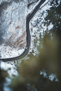 Aerial view of road amidst snow covered land
