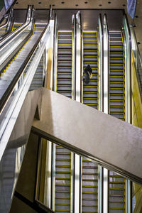 High angle view of woman standing on escalator