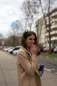 Woman smoking cigarette at street