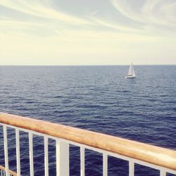 Sailboat sailing on sea against sky