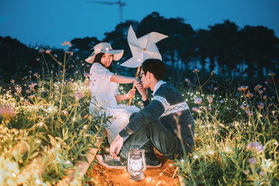 Couple sitting on field