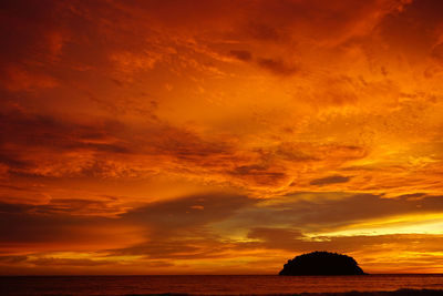 Scenic view of dramatic sky over sea during sunset