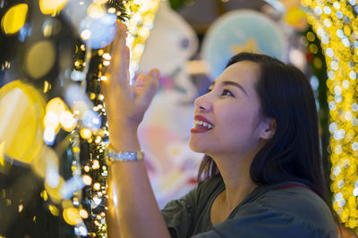 Portrait of smiling young woman looking away