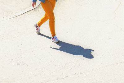 Low section of man walking on street