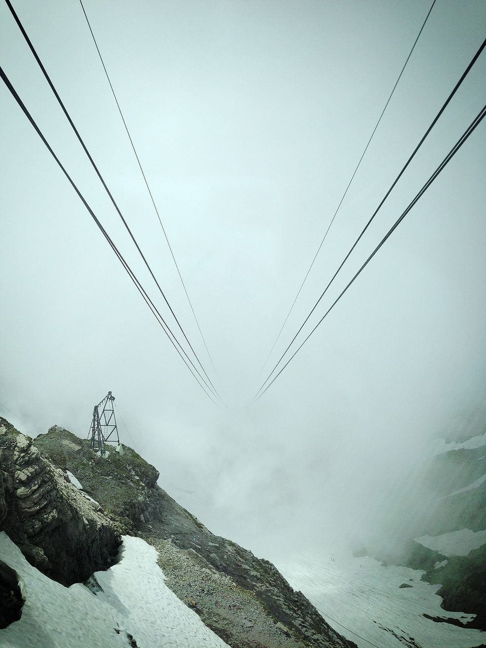 mountain, power line, cable, snow, connection, electricity pylon, overhead cable car, winter, scenics, tranquility, tranquil scene, low angle view, sky, electricity, cold temperature, beauty in nature, nature, mountain range, weather, power supply