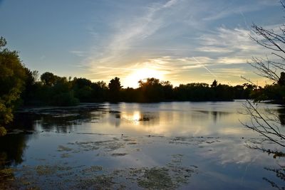 Scenic view of lake at sunset