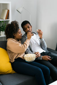 Side view of senior couple sitting on sofa at home