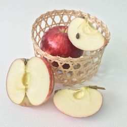 Close-up of apple on table against white background