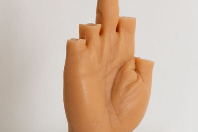 Close-up of woman hand against white background