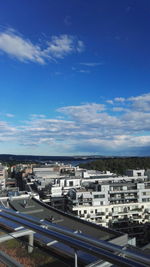 High angle view of cityscape against blue sky