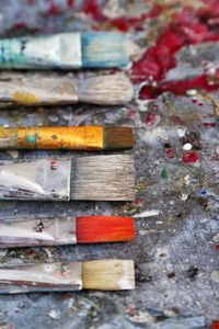 Close-up of paintbrushes on dirty table