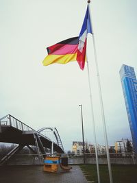 Low angle view of flags against clear sky