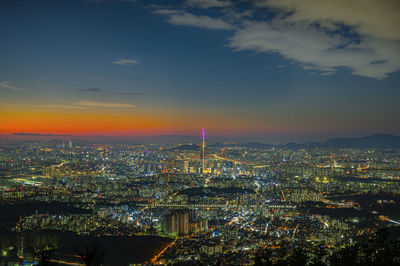 High angle view of city lit up at dusk