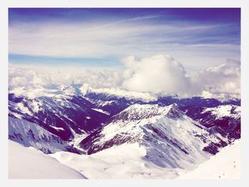 Aerial view of snowcapped mountains against sky