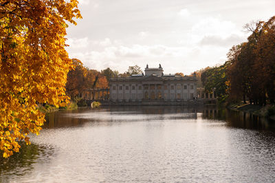 Bridge over river against sky during autumn