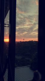 View of sunset through window