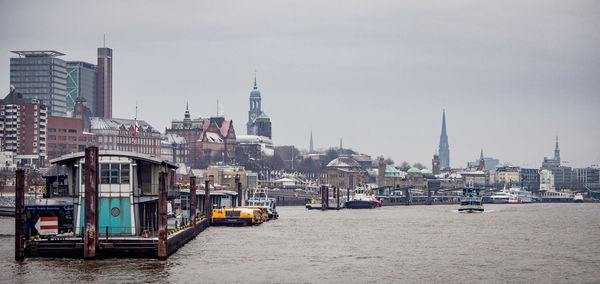 Boats in river with buildings in background