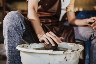 Close-up of artist making pot at workshop