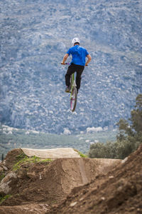 Low angle view of man jumping while doing bmx cycling