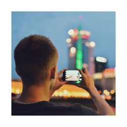 Rear view of man photographing