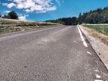 Surface level of country road against sky