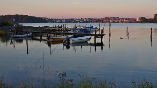 Fishing boats in harbor at sunset