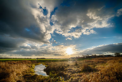 Scenic view of field against sky during sunset