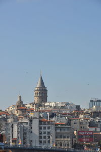 Buildings in city against clear sky